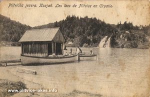 Small wooden pier, boats and waterfall at Kozjak Lake, Plitvice in 1900s