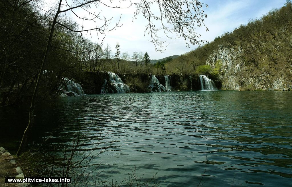 Walking along Milanovac lake with views over waterfalls